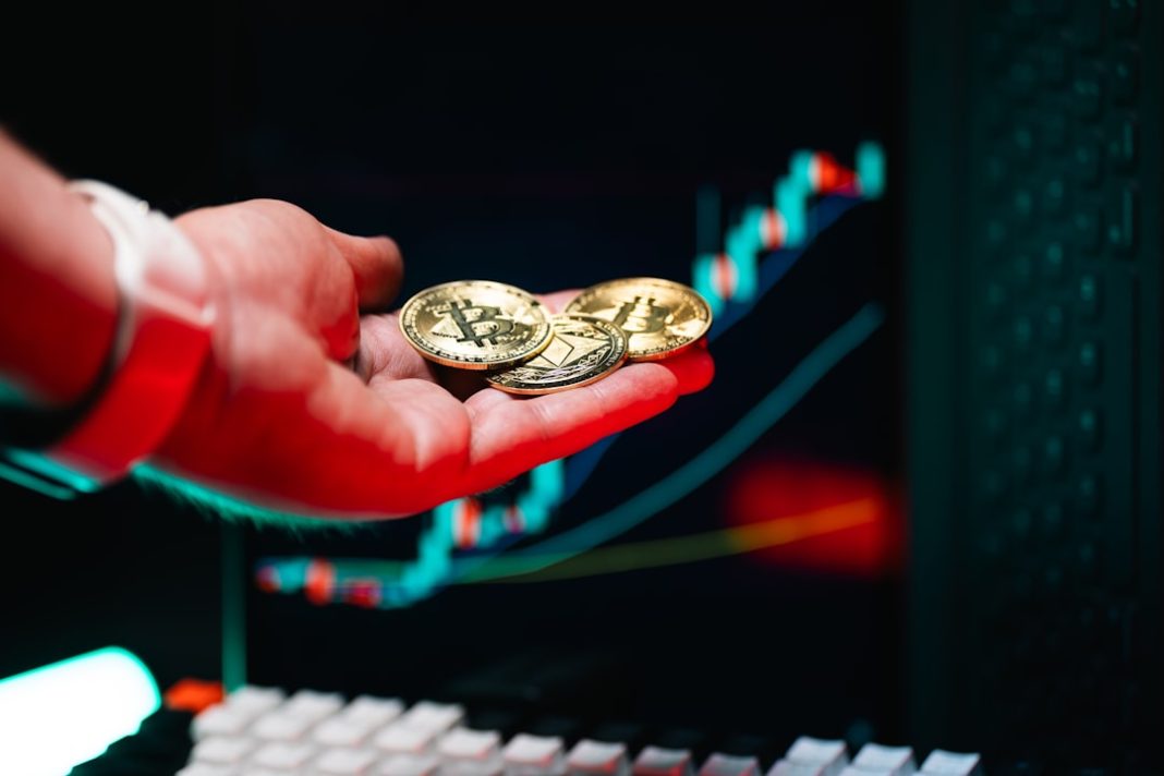 A person holding two gold coins in their hand
